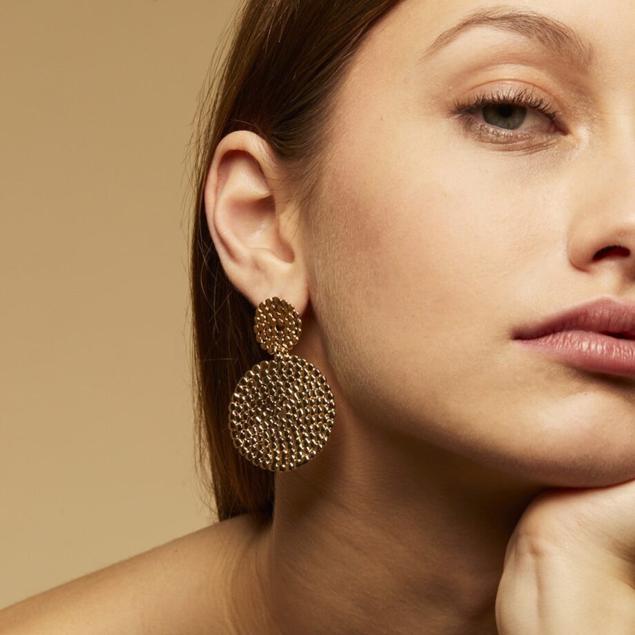 Gas Bijoux gold coin earrings on person